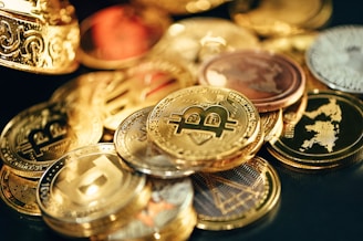 a pile of gold and silver coins sitting on top of a table