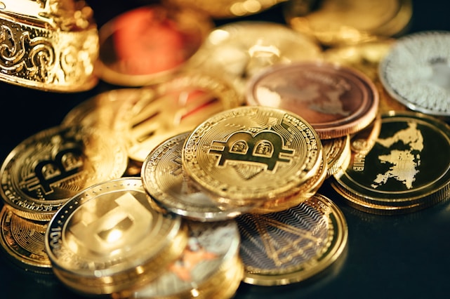 a pile of gold and silver coins sitting on top of a table