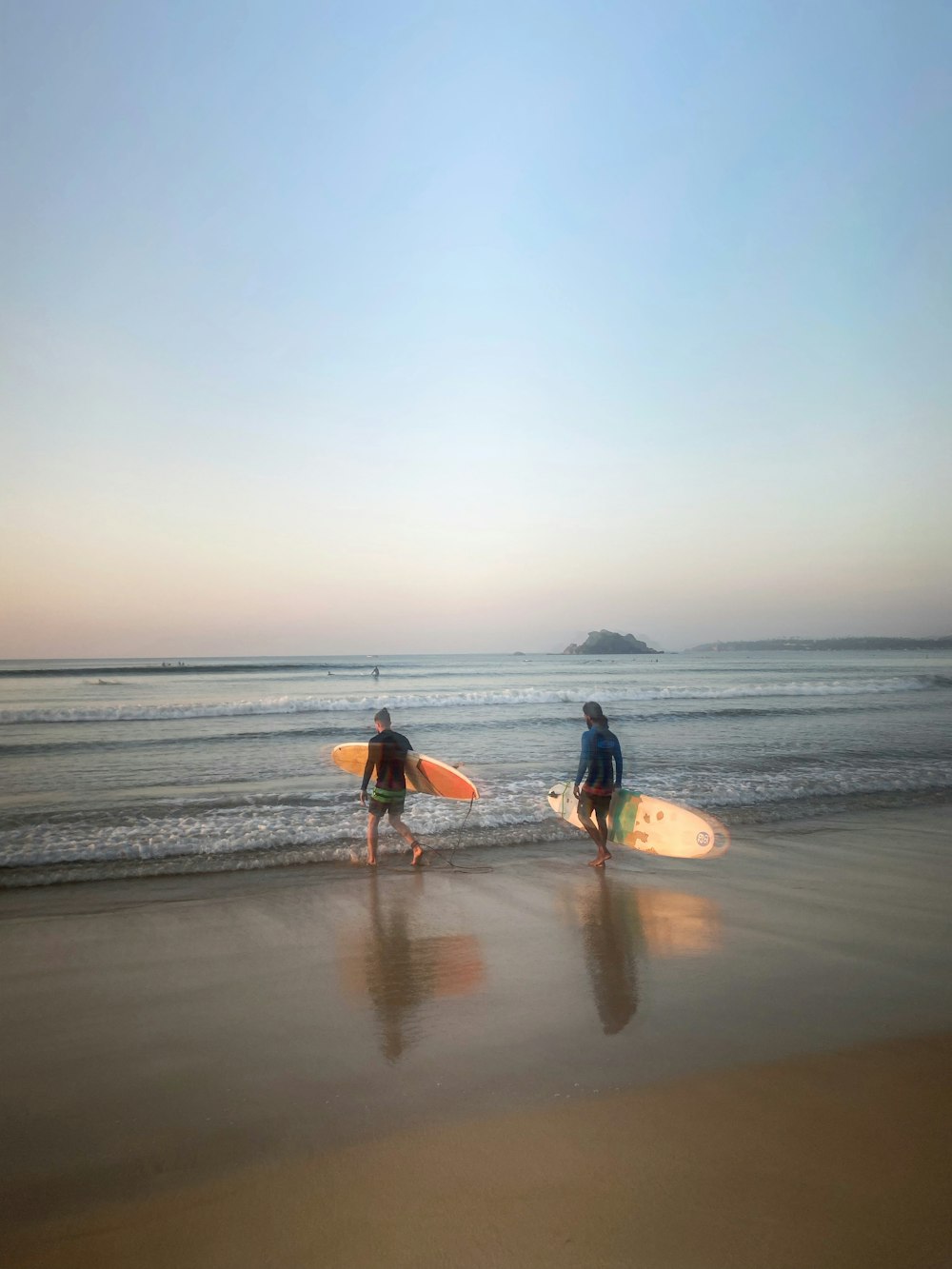 a couple of people that are standing in the sand