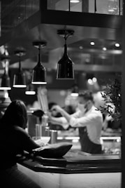 a black and white photo of people in a restaurant