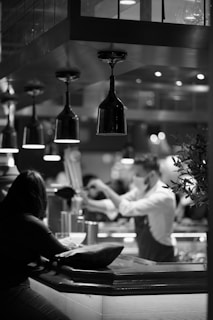 a black and white photo of people in a restaurant