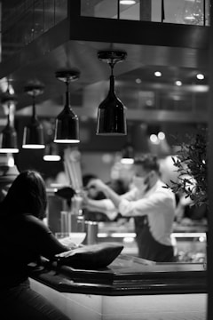 a black and white photo of people in a restaurant