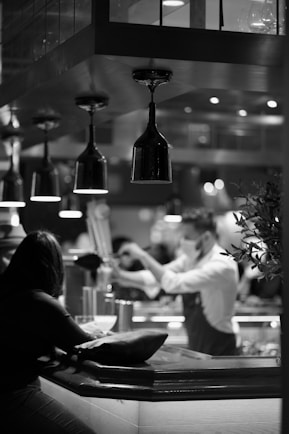 a black and white photo of people in a restaurant