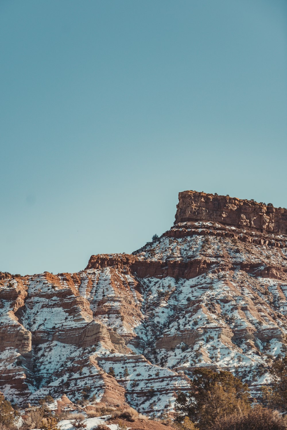 a snow covered mountain with a blue sky in the background