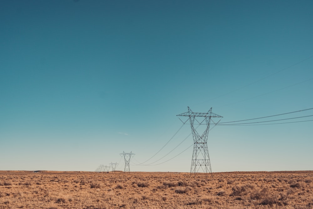 a field with power lines in the distance