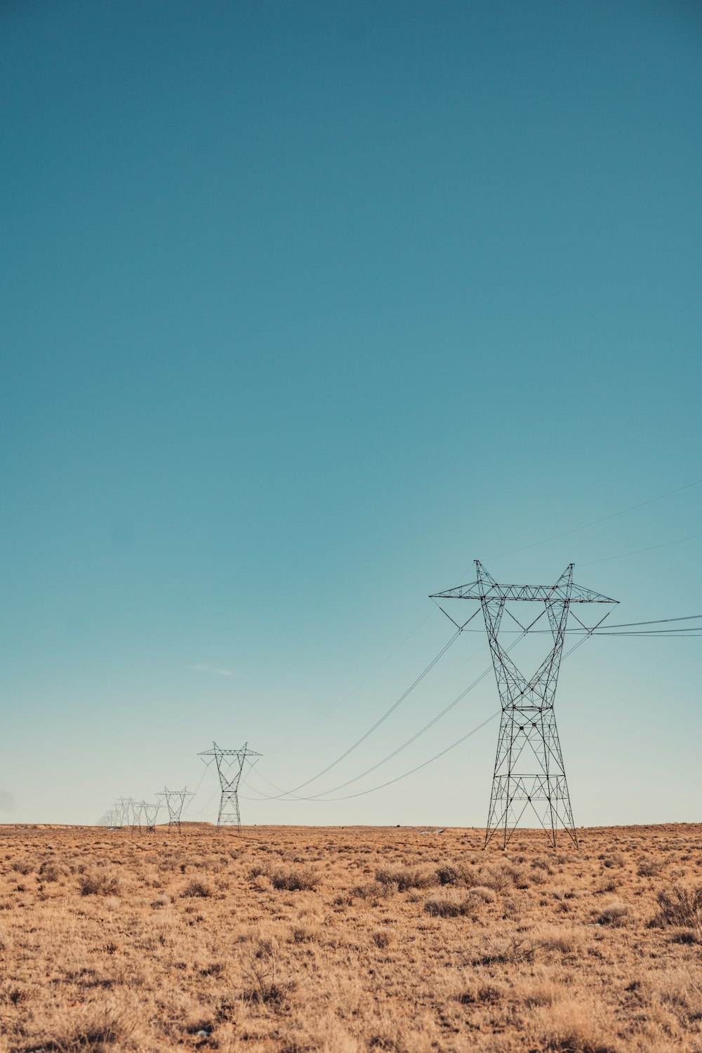 a couple of power lines sitting in the middle of a field