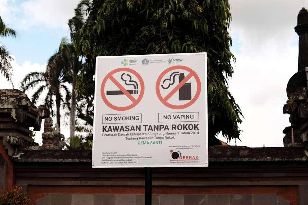 a no smoking sign in front of a building