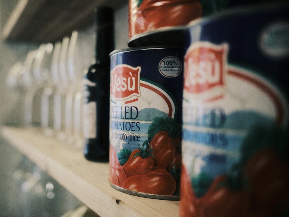 canned tomatoes are on a shelf in a grocery store