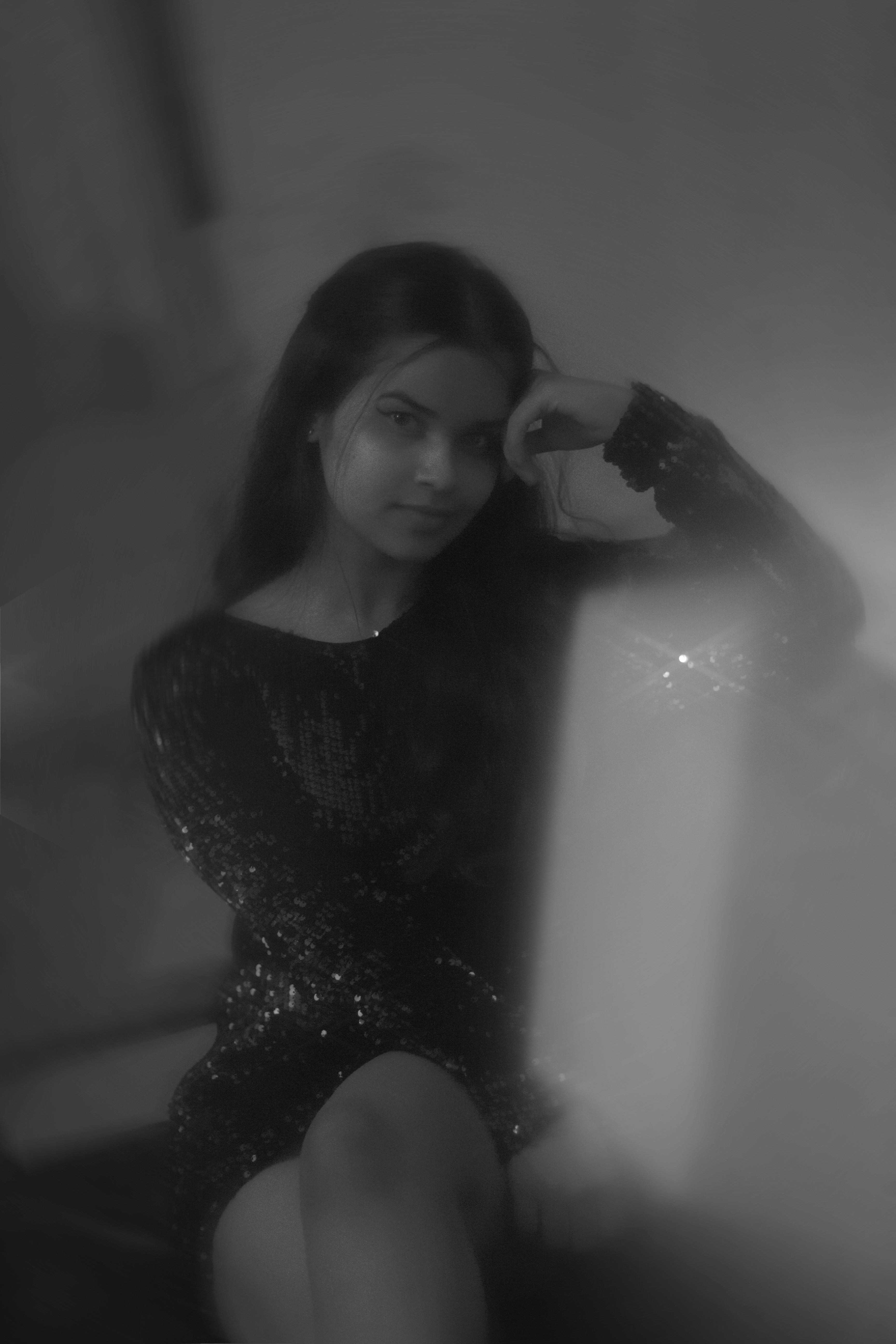 A woman in a black dress sitting on a chair photo – Free People Image ...
