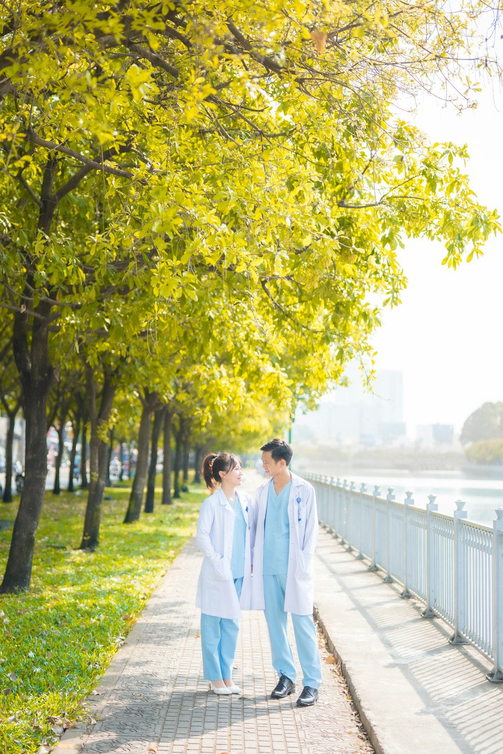 a couple of people that are walking down a sidewalk