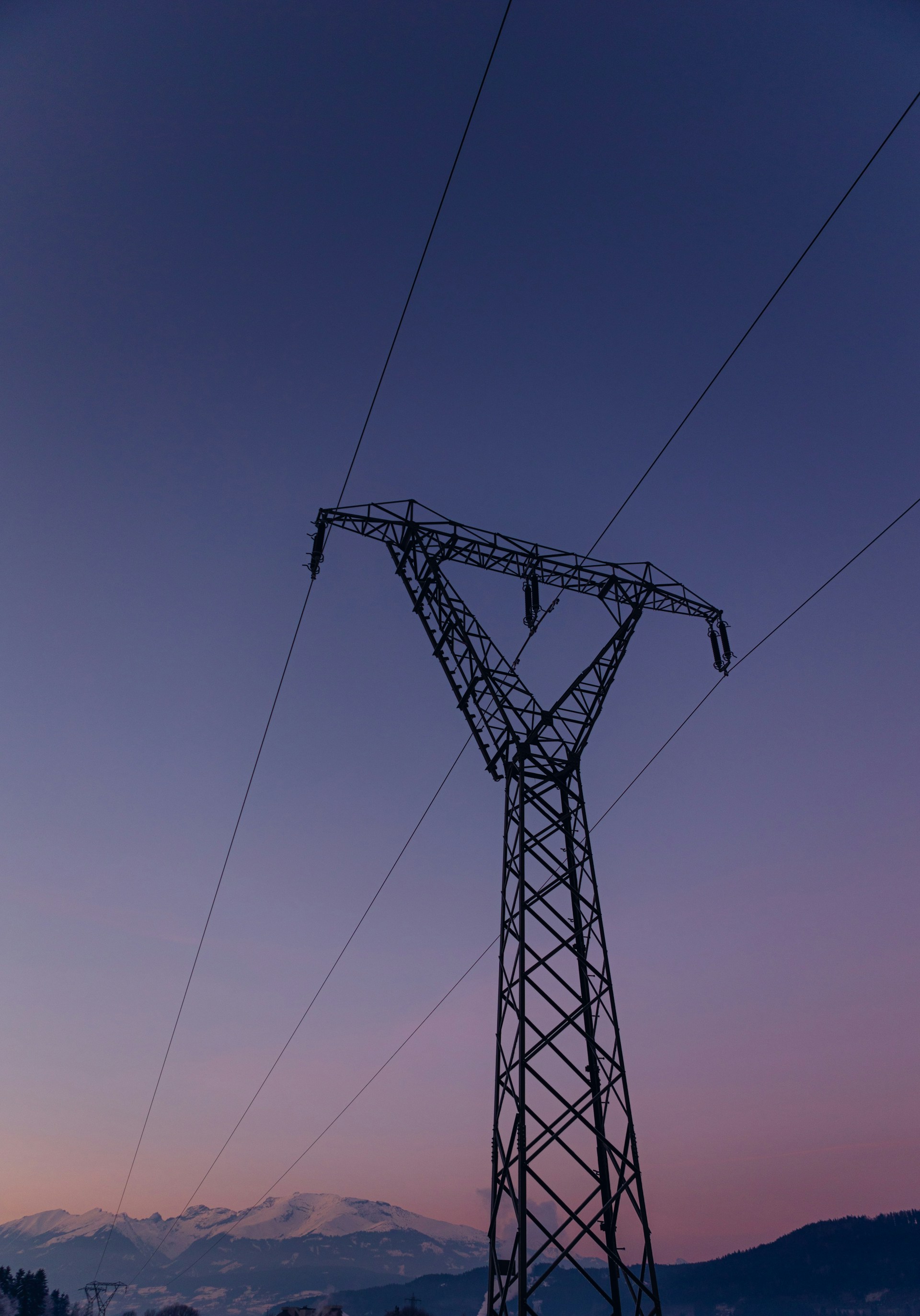 a power line with mountains in the background