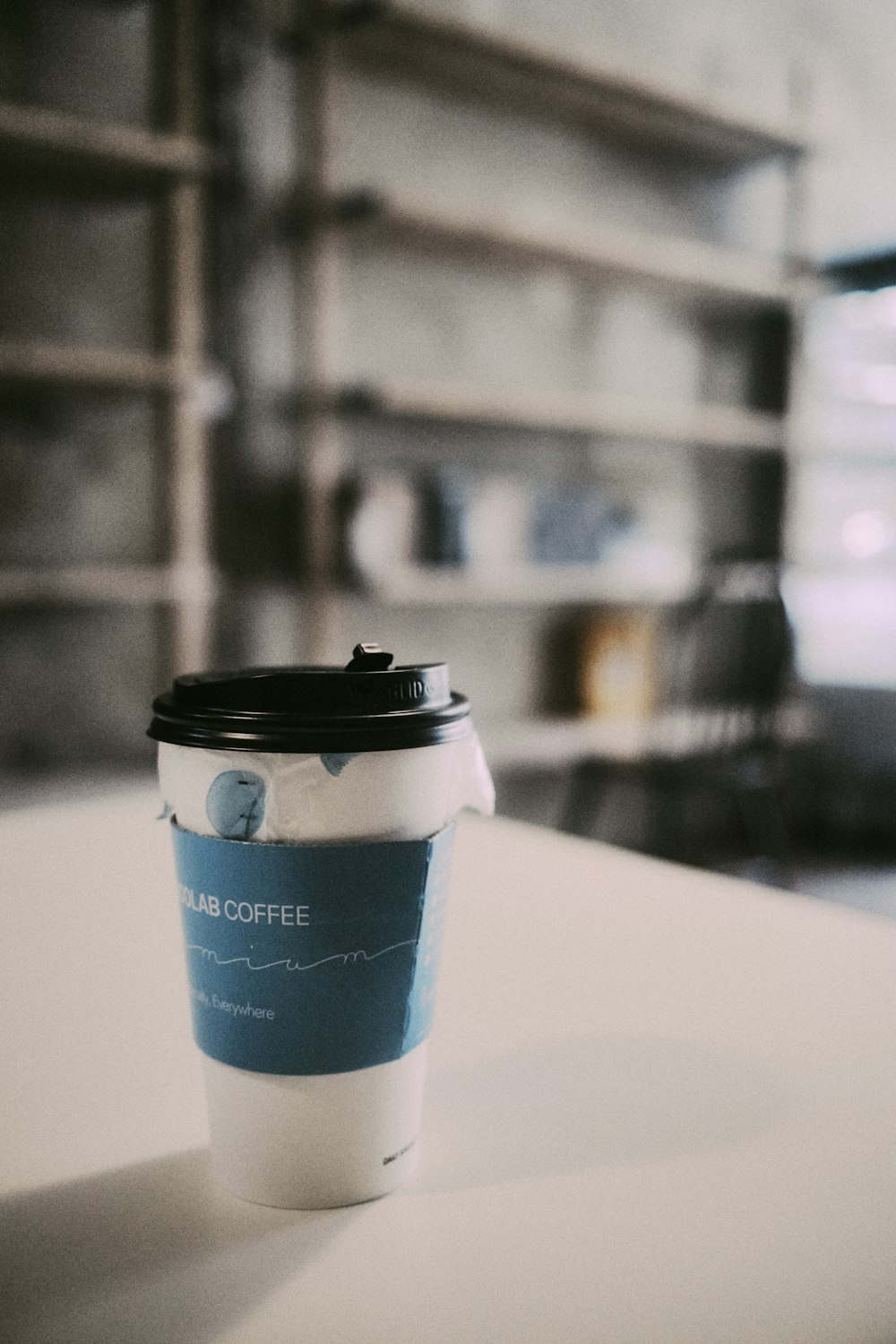 a cup of coffee sitting on top of a table