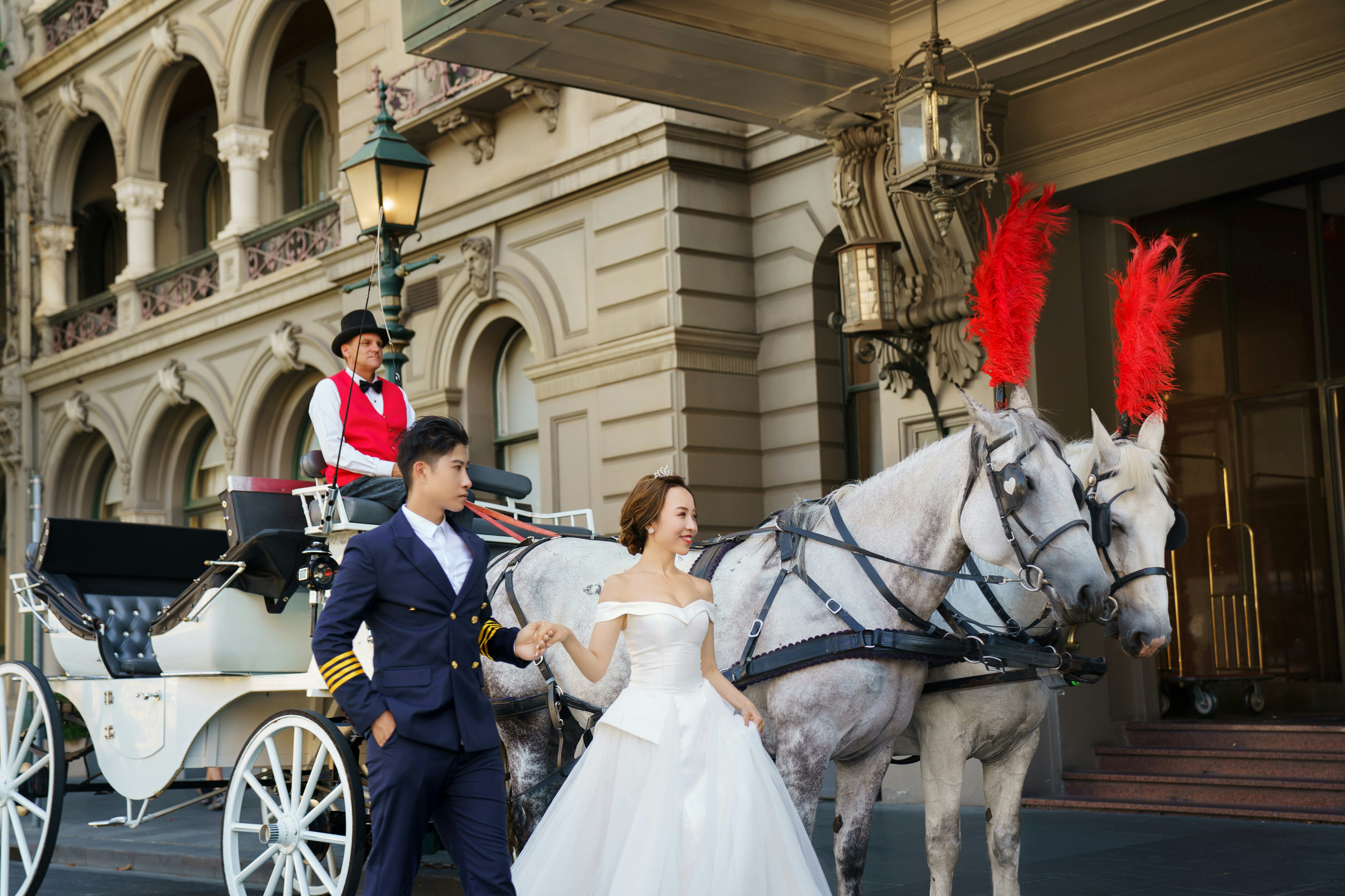 a man and a woman in a white wedding dress are standing next to a horse