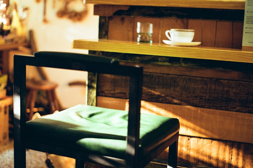 a chair sitting in a room next to a shelf