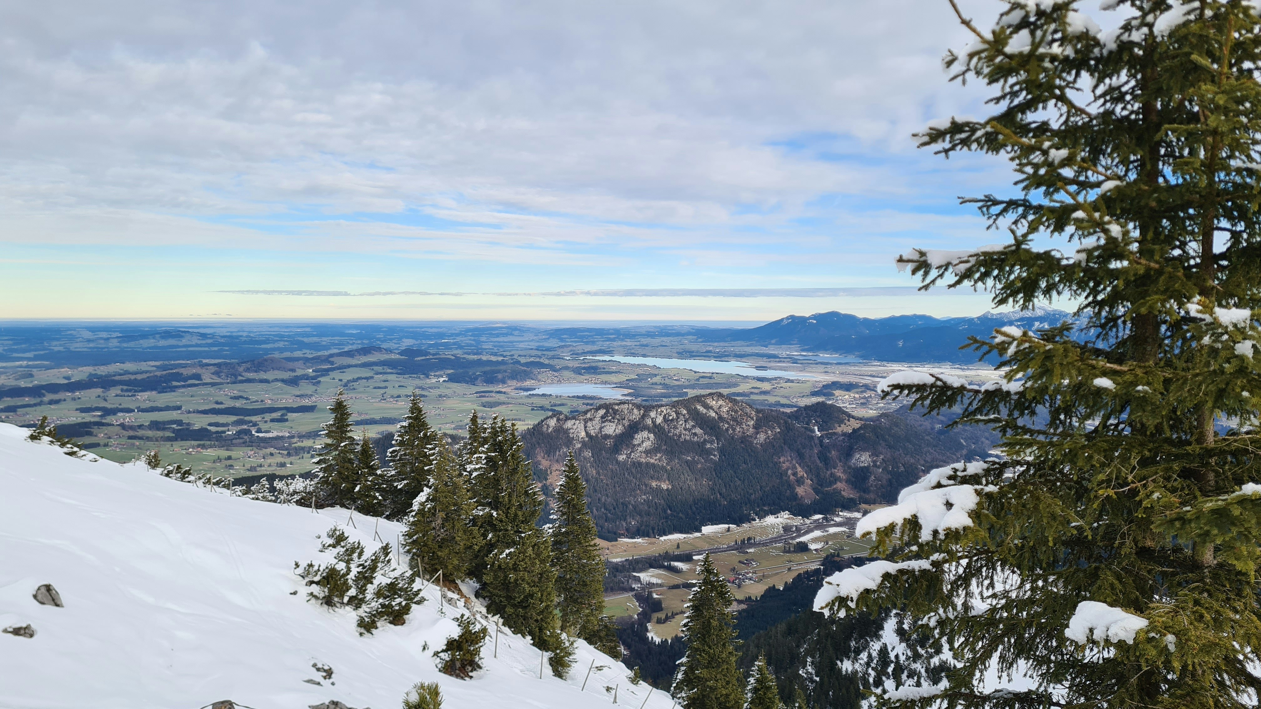 a snow covered mountain with a view of a valley