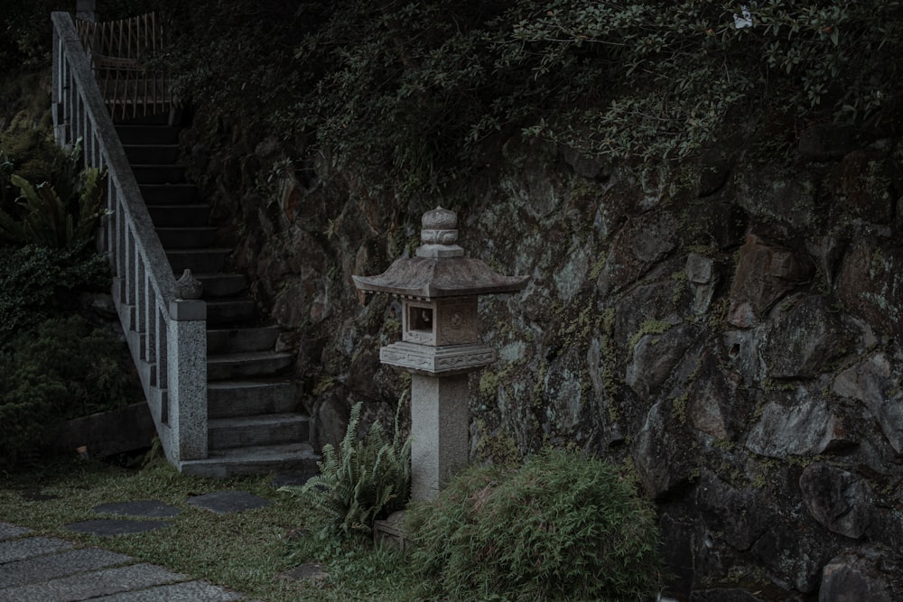 a stone stairway leading up to a stone wall