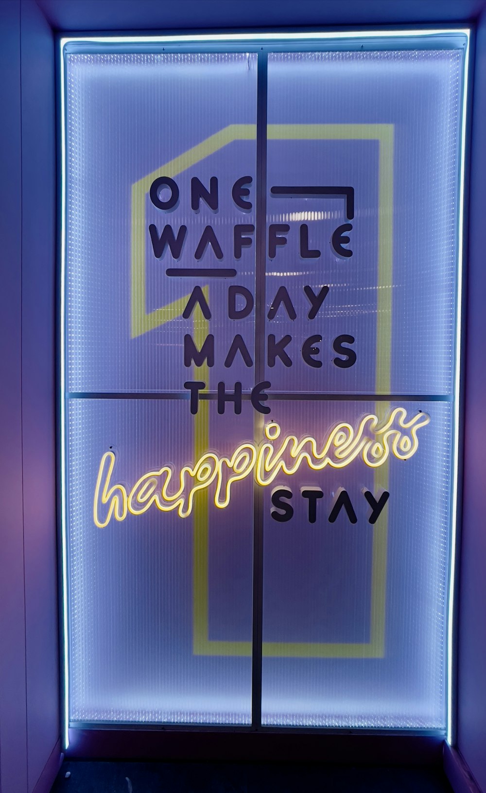a neon sign that reads one wave a day makes the happiness stay