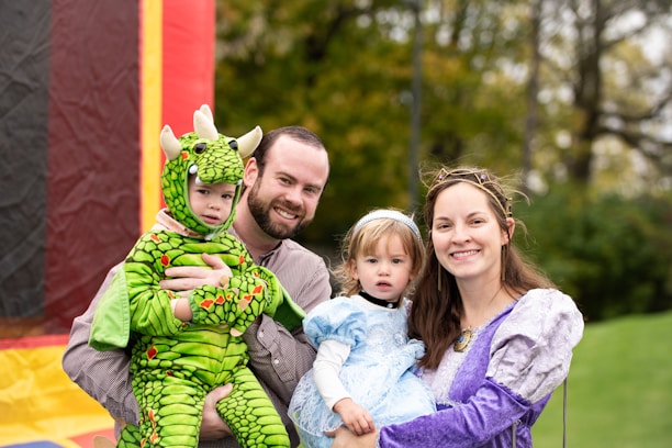 a man, woman and child pose for a picture in front of a boun