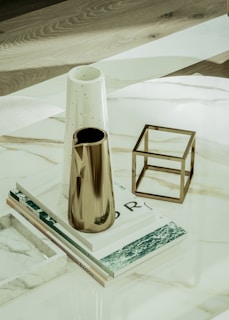 a table with a vase and a book on it