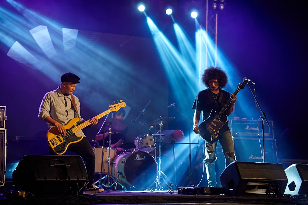 a group of people on a stage with guitars