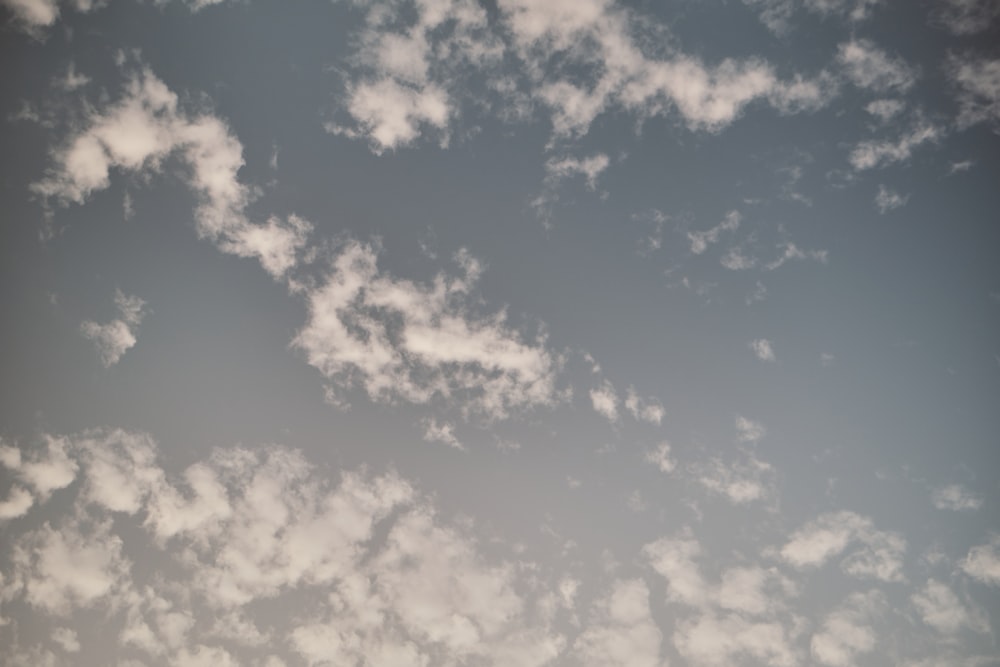 a plane flying in the sky with a lot of clouds