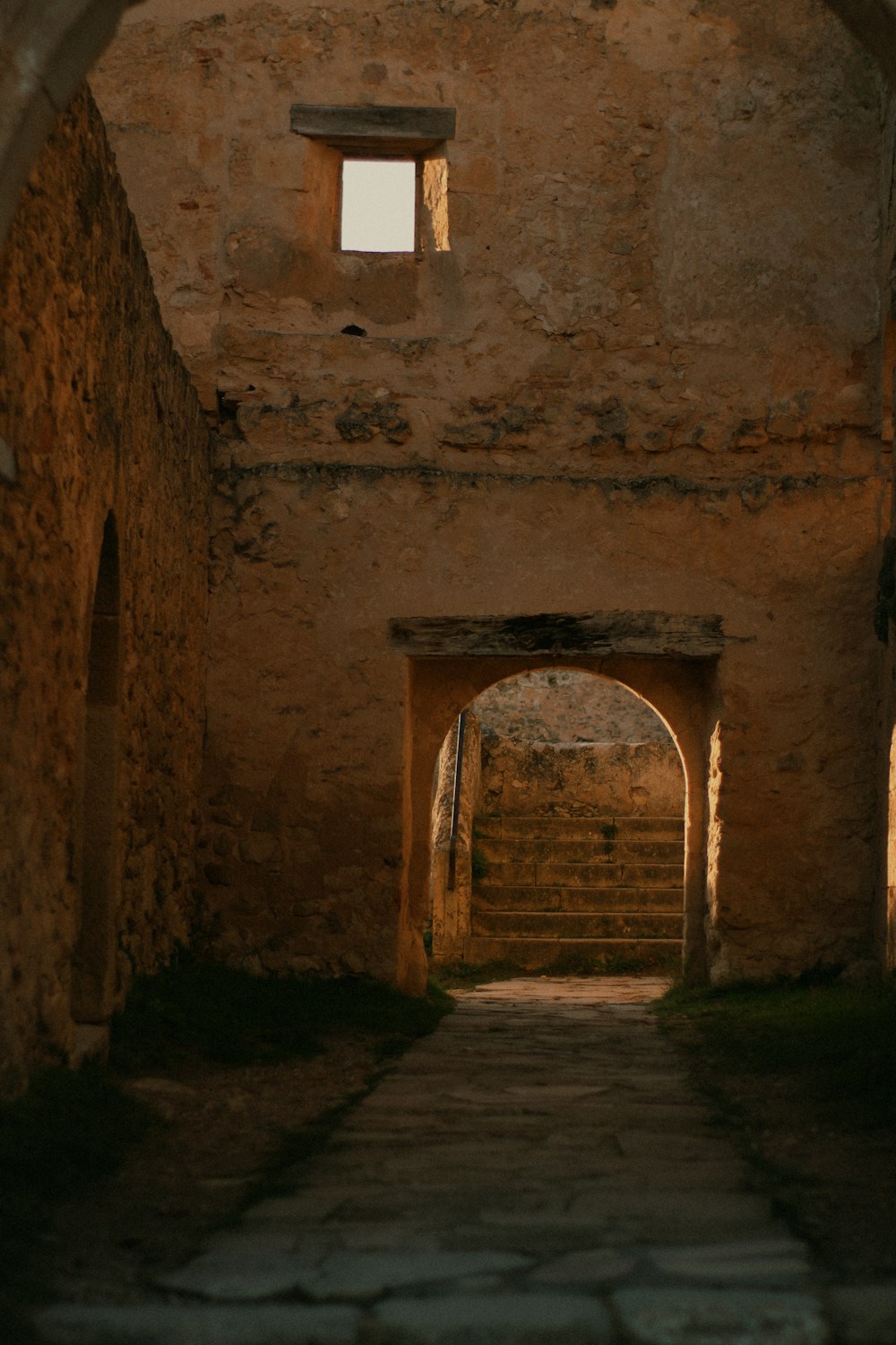 a stone building with a stone walkway leading into it