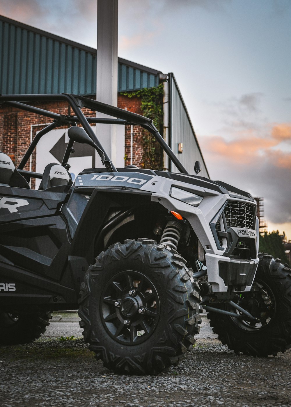 a polaris rzr xp4 is parked in front of a building