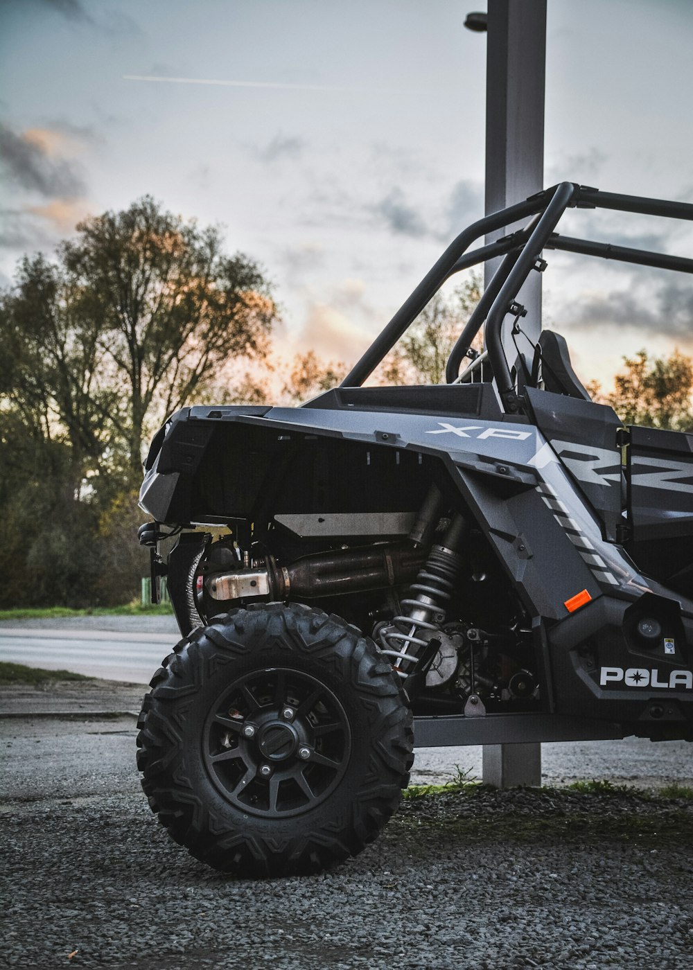 a polaris rzr is parked on the side of the road