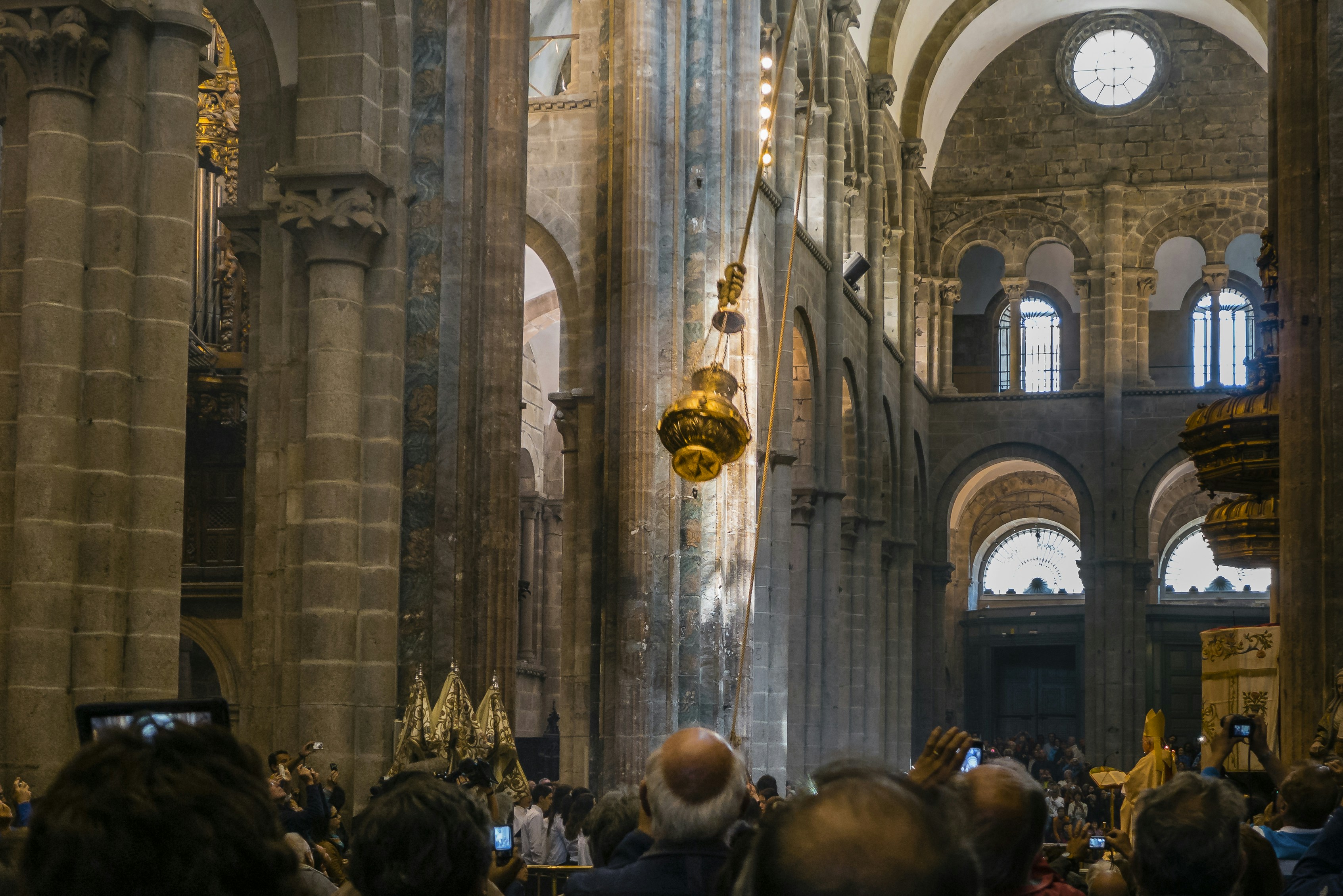 a large group of people in a large building, Waving the fumero at the Cathedral of Santiago de Compostela, Spain