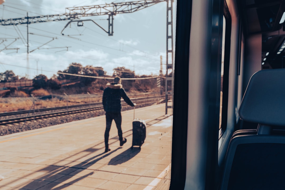 a man with a suitcase walking on a train platform,