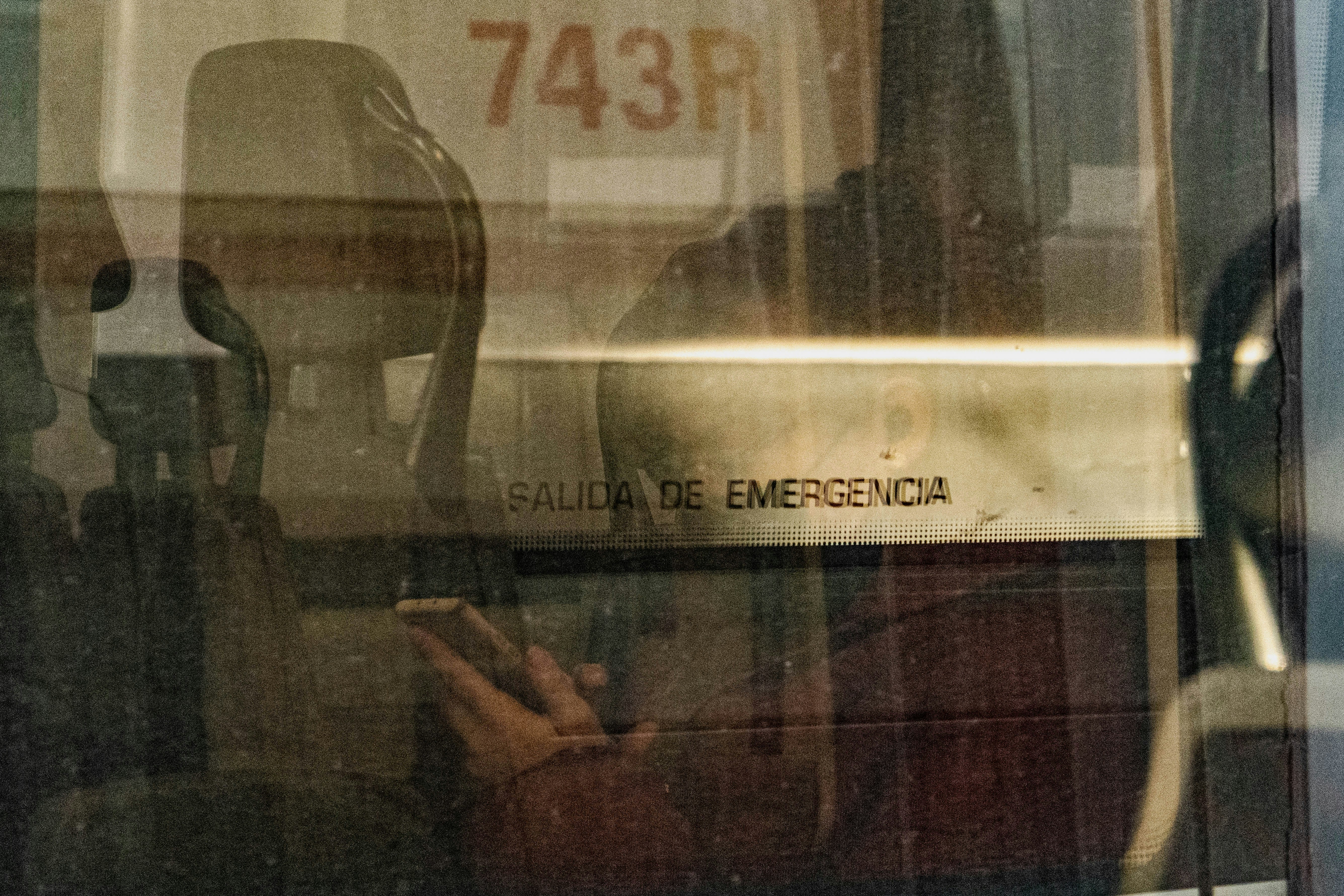 a person sitting in a chair looking at a cell phone