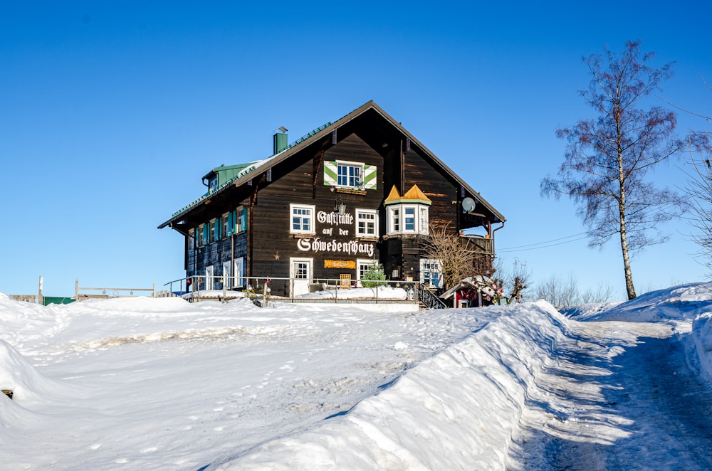 a house on a hill covered in snow