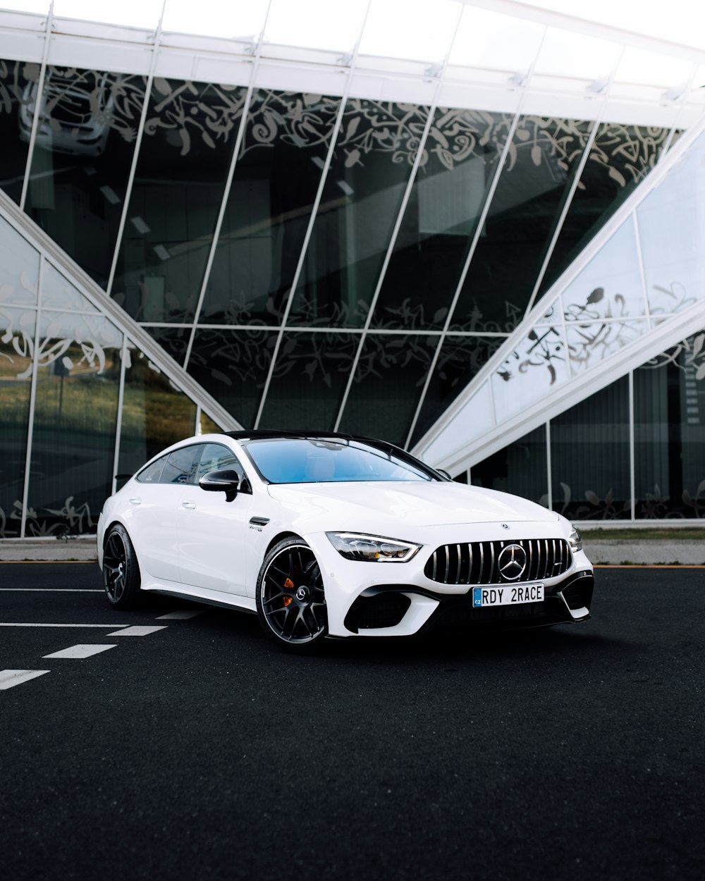 a white car parked in front of a building