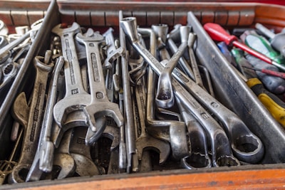 Close-up of a vibrant rainbow-colored wrench resting on a workbench with tools.