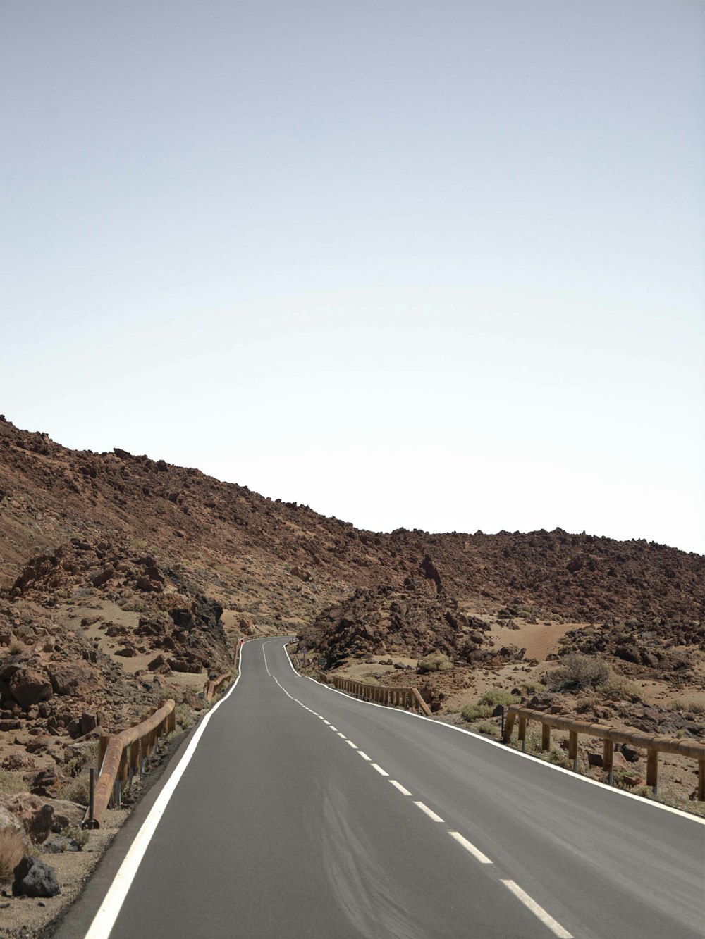 an empty road in the middle of the desert