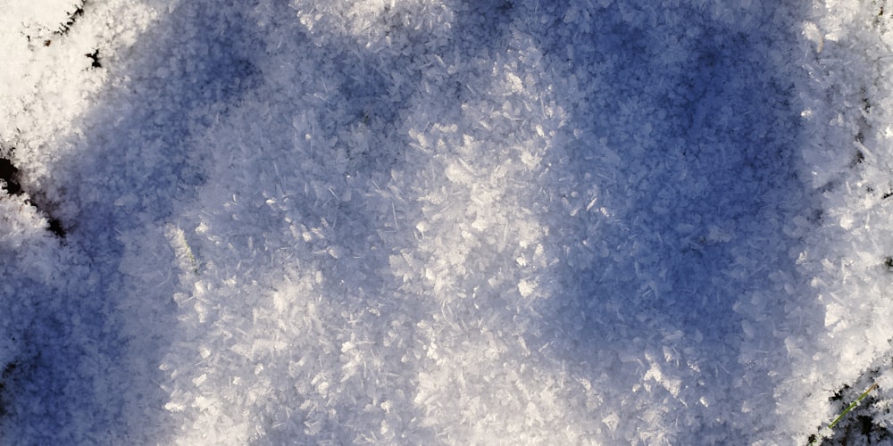 a snow covered ground with a blue sky in the background