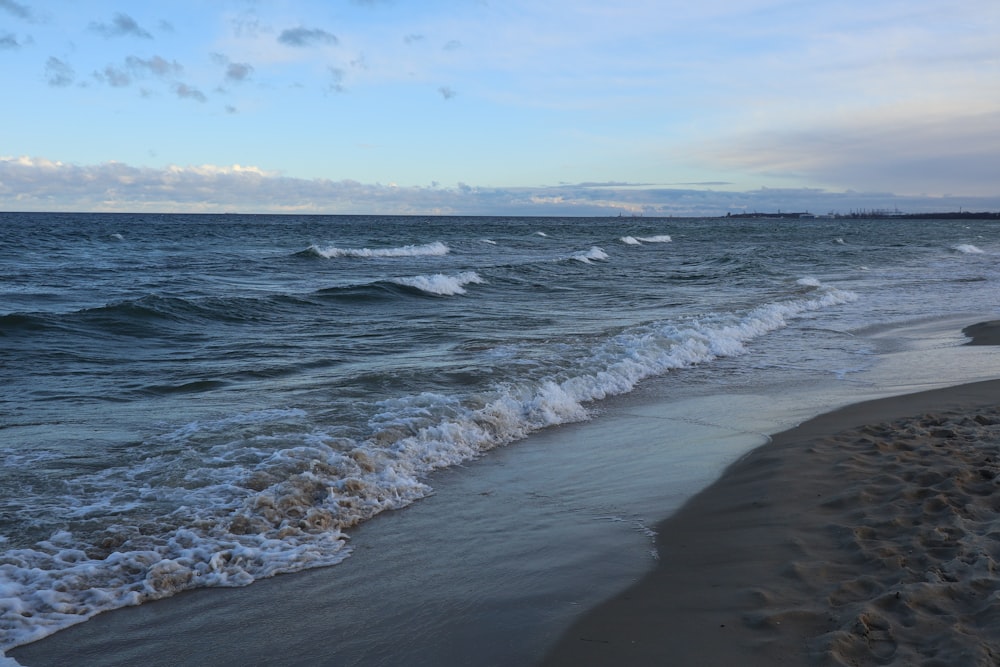 a beach with waves coming in to shore