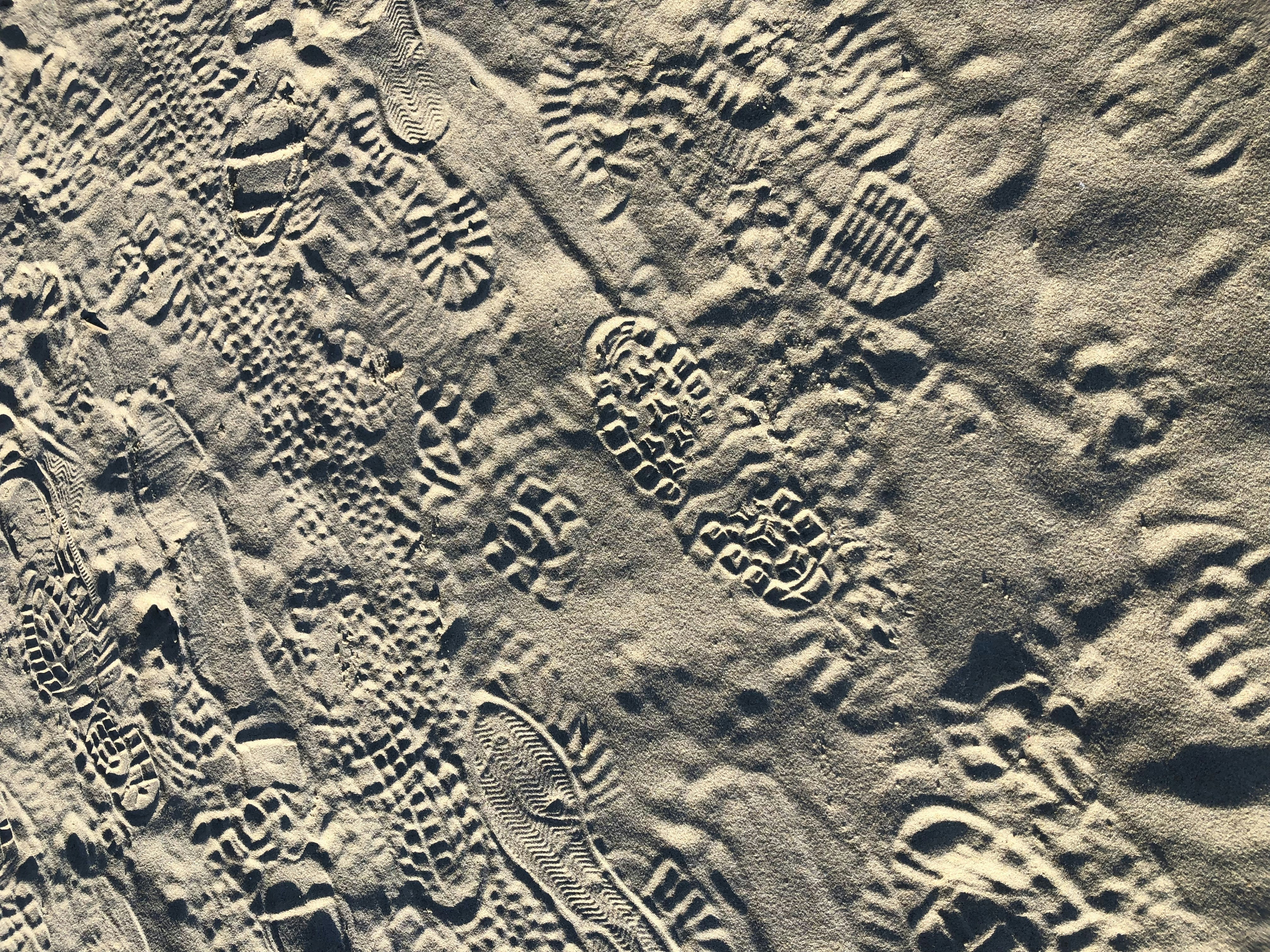 a close up of sand with footprints on it