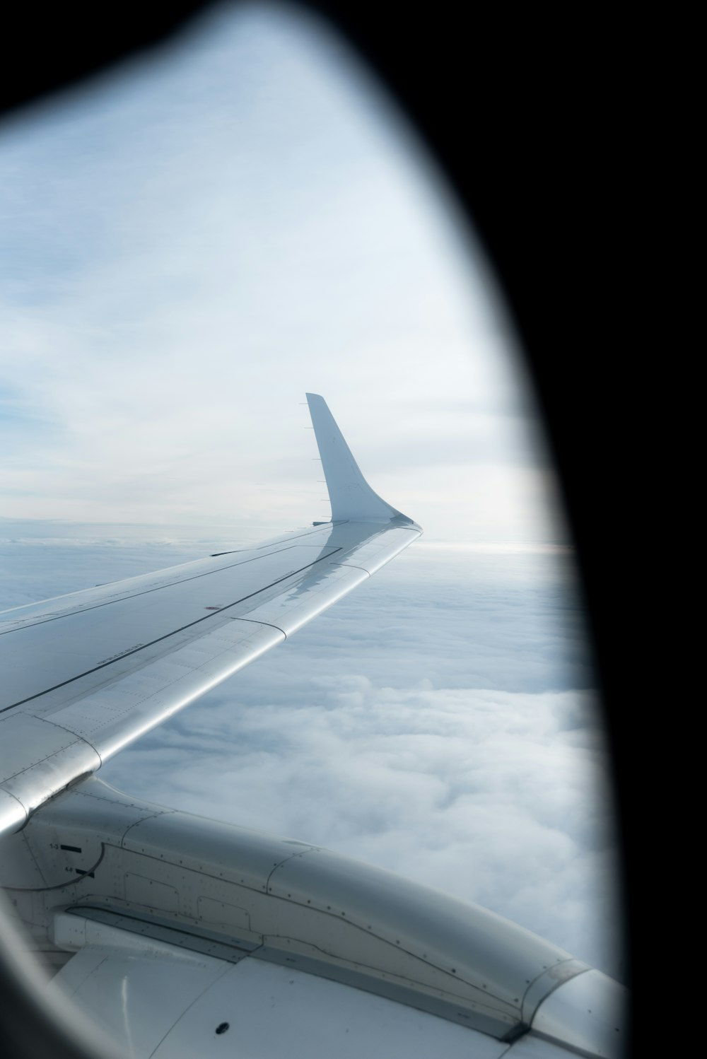 the wing of an airplane as seen through a window