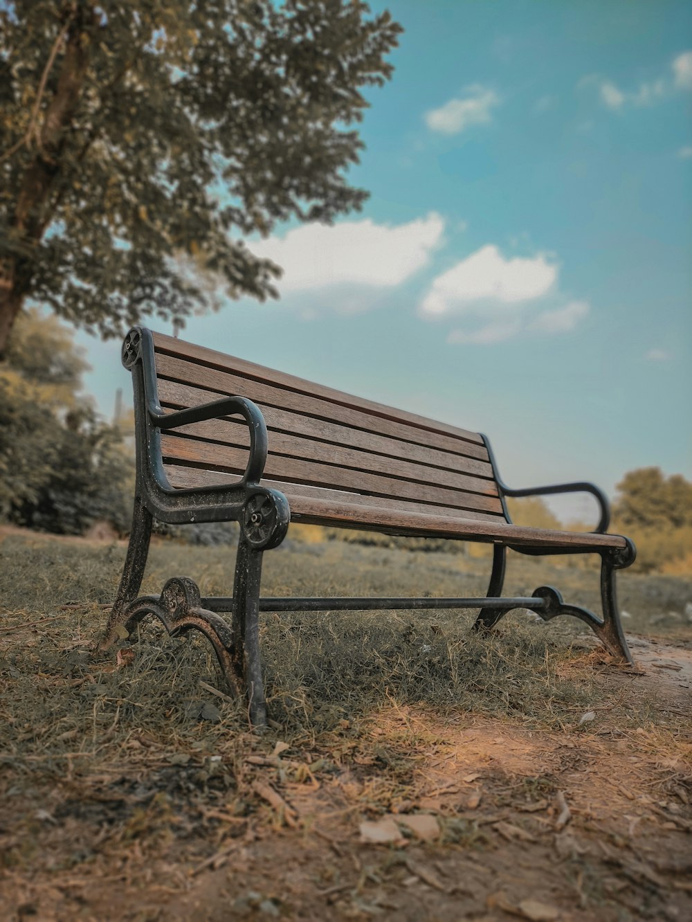 a wooden bench sitting in the middle of a field