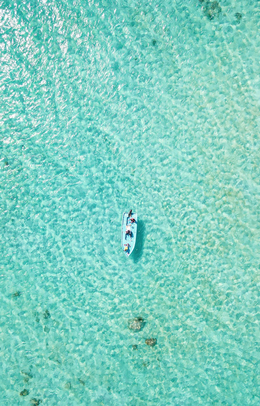 a small boat floating on top of a body of water