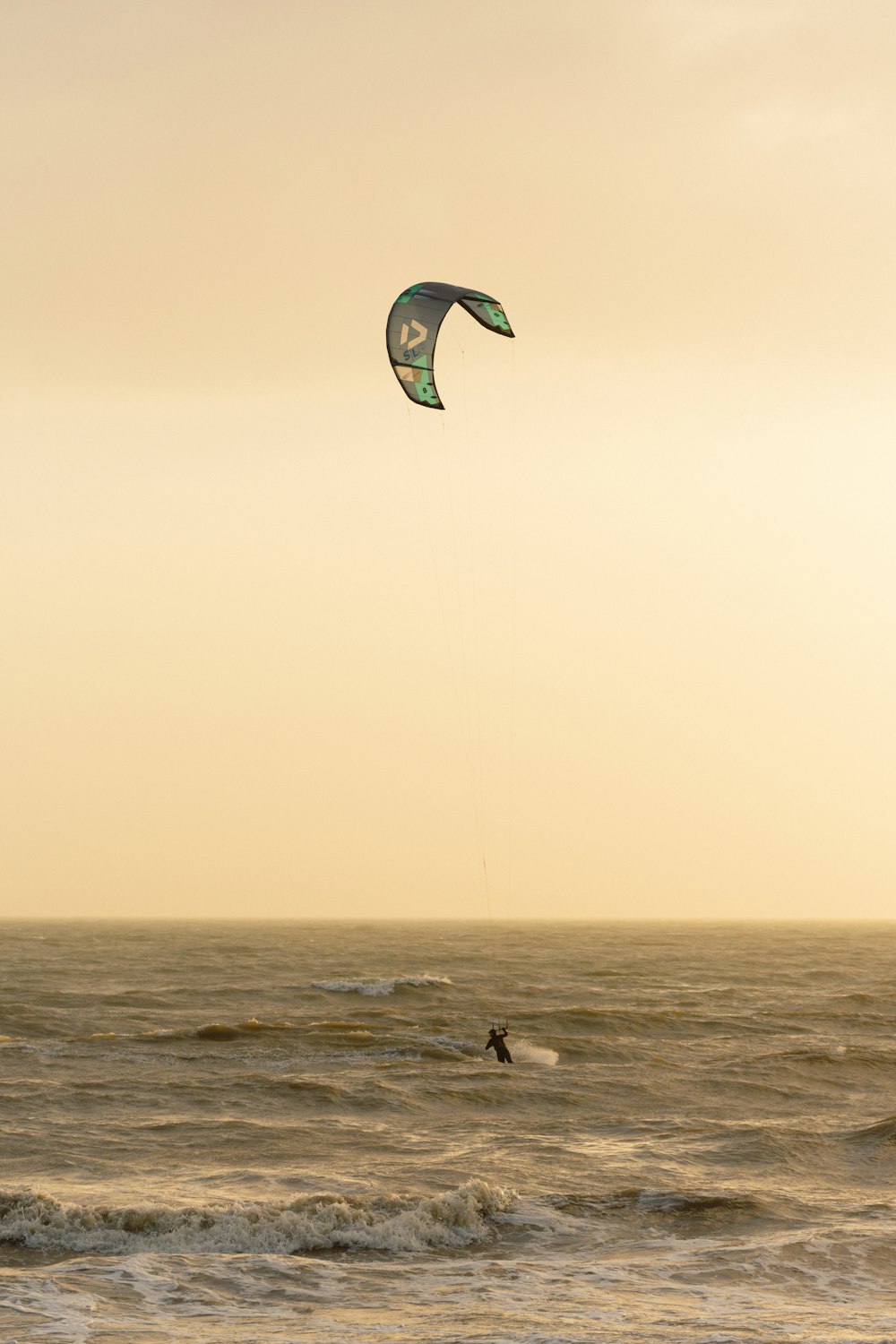 a person para sailing in the ocean at sunset