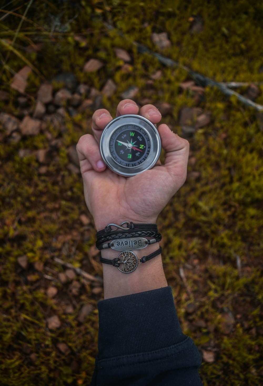 a person holding a compass in their hand