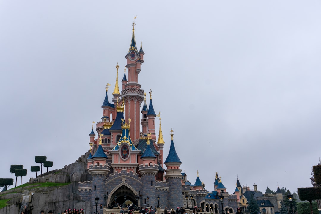 a castle with a lot of people standing in front of it,