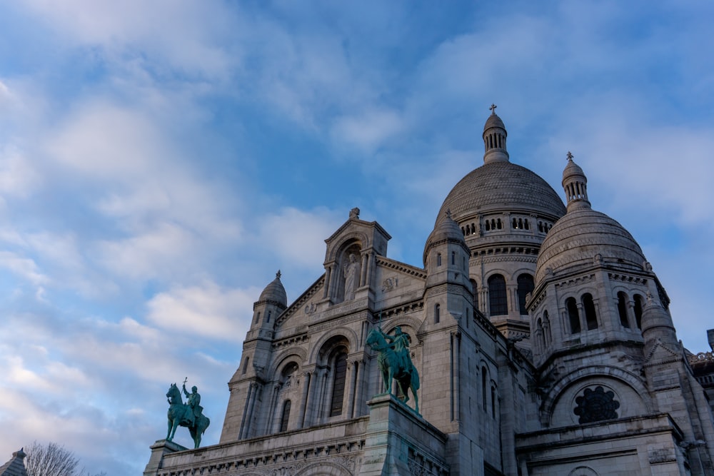 a large building with a statue on top of it