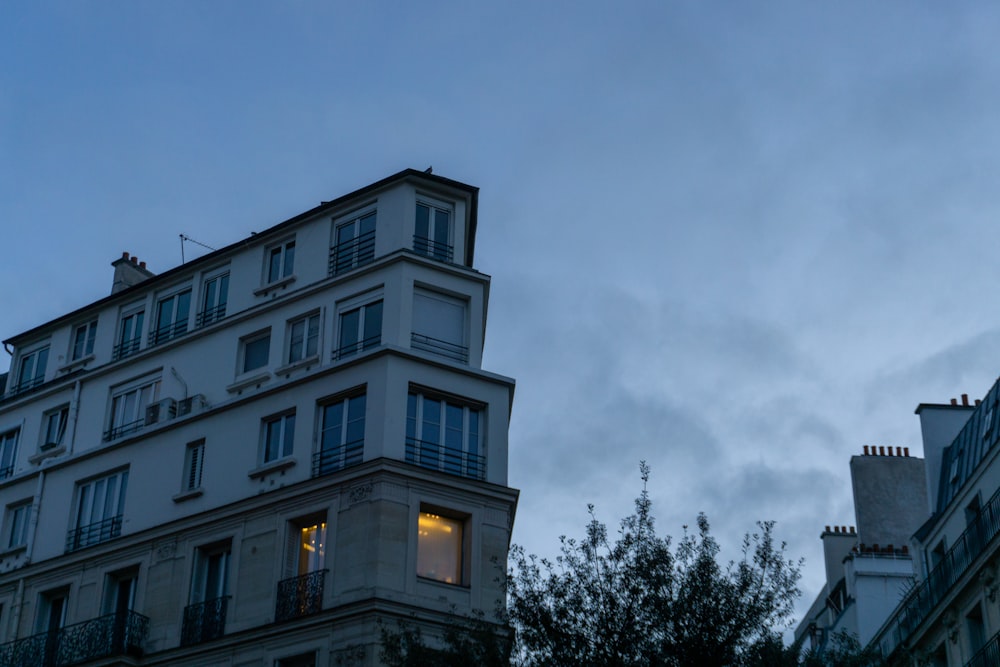 a very tall building sitting next to a tree