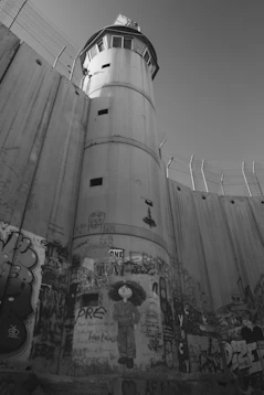 a tall tower with graffiti on the side of it