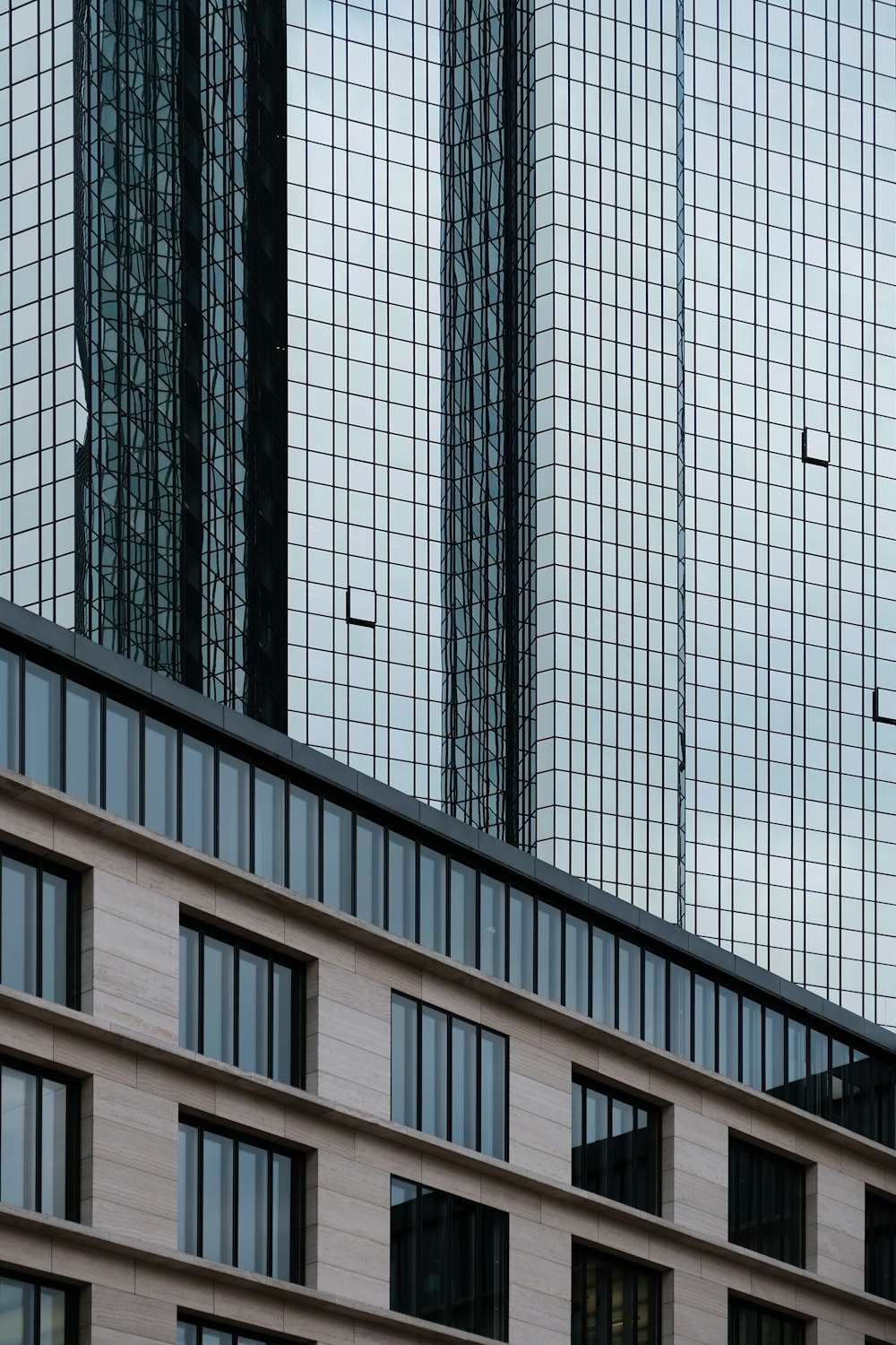 an airplane flying over a building with many windows