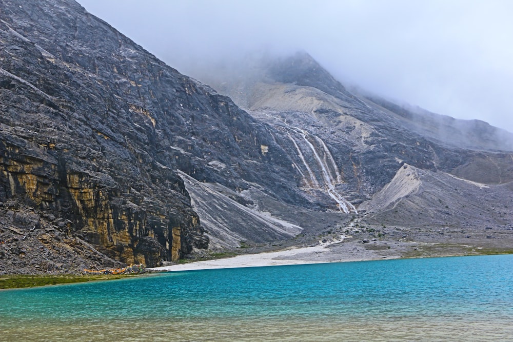 a mountain with a body of water in front of it