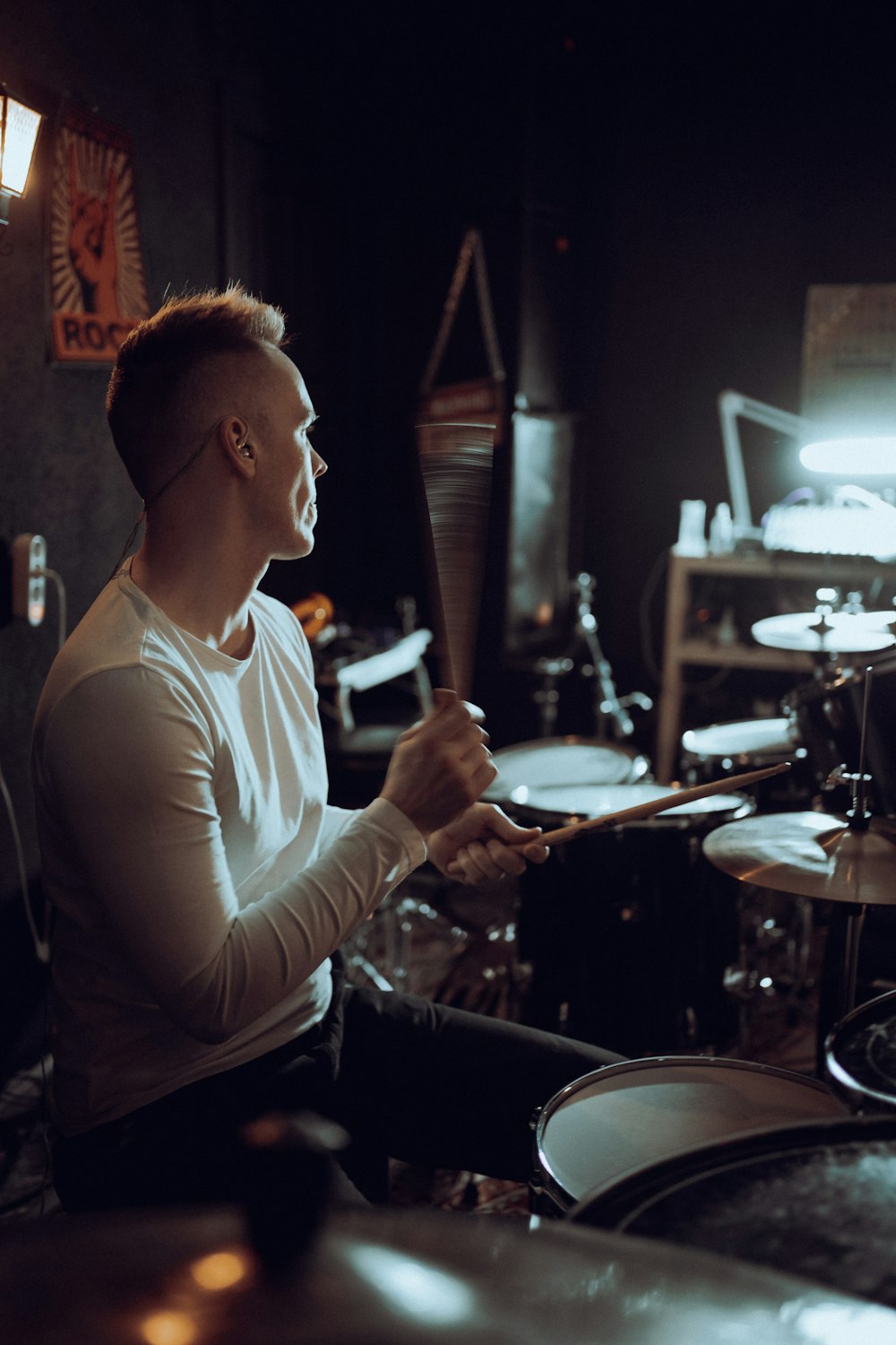 a man sitting in front of a drum set